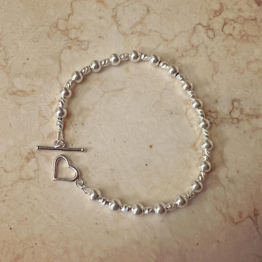 Bracciale sferette e pepite diamantate con chiusura a cuore